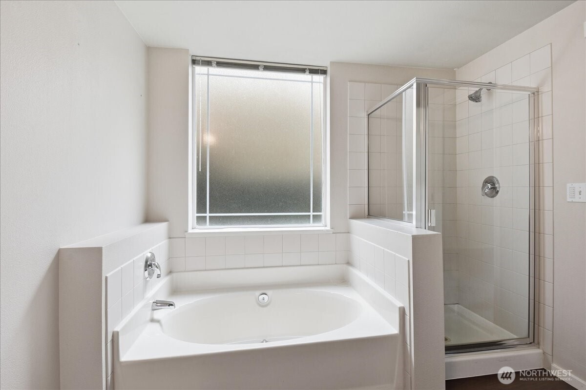 107 164th Street Southeast, Unit 2103 Bothell, WA 98012 - Photo 19 of 24 a white bath tub sitting next to a shower