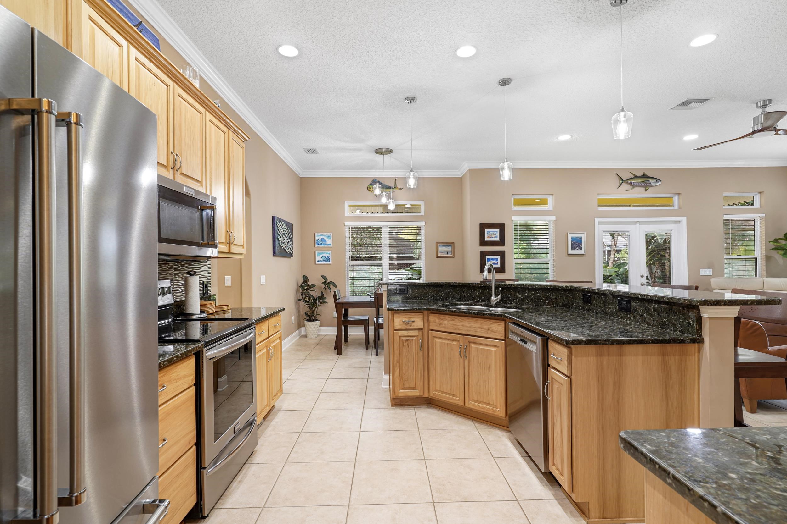 509 Twentieth Street St. Augustine, FL 32084 - Photo 14 of 40 a kitchen with stainless steel appliances granite countertop a sink stove and refrigerator