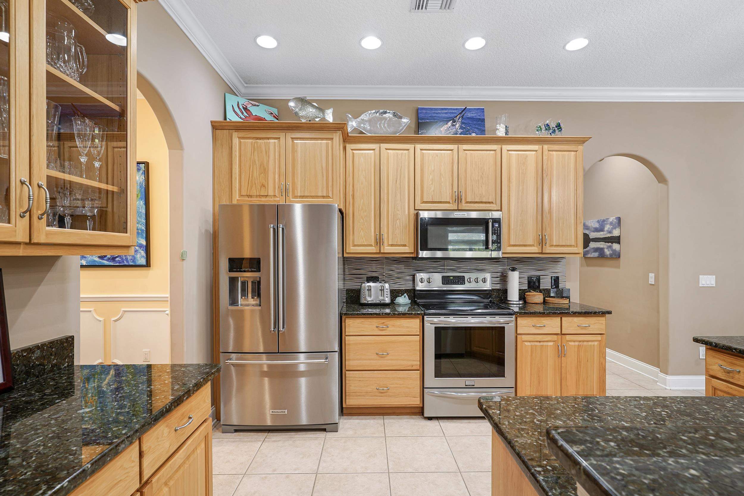 509 Twentieth Street St. Augustine, FL 32084 - Photo 15 of 40 a kitchen with stainless steel appliances granite countertop a refrigerator a stove and a sink with wooden floor