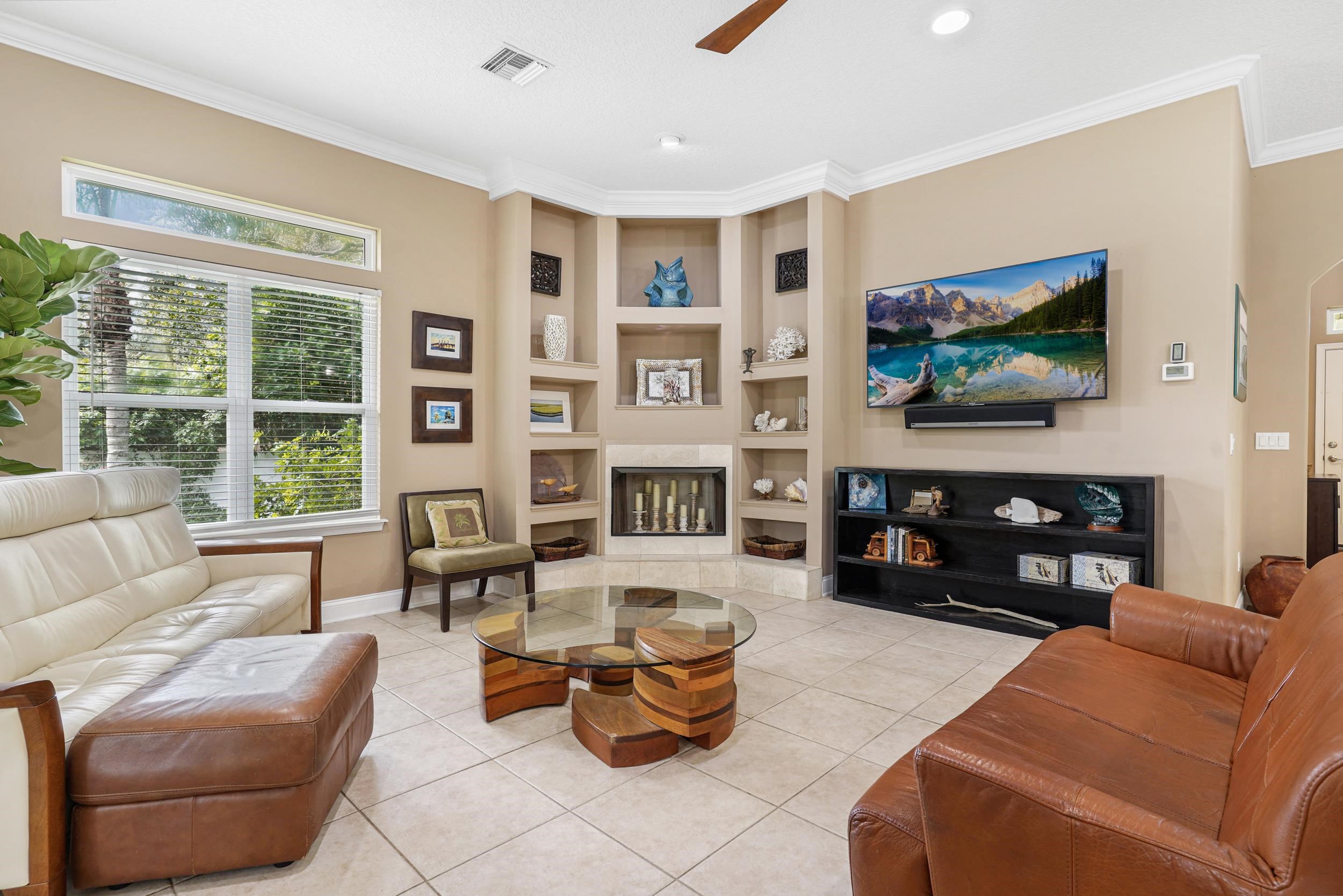 509 Twentieth Street St. Augustine, FL 32084 - Photo 17 of 40 a living room with furniture a fireplace and a flat screen tv