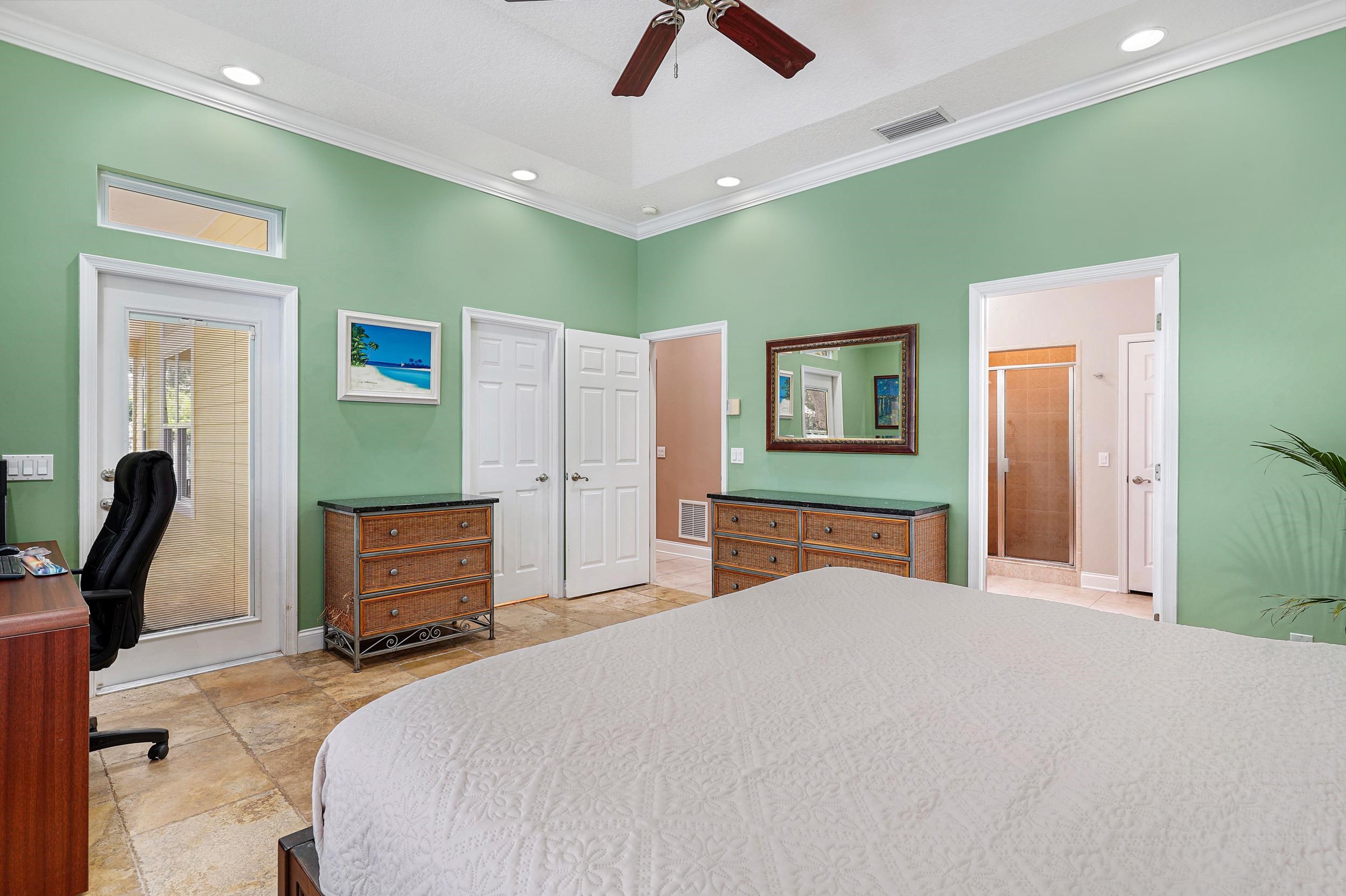 509 Twentieth Street St. Augustine, FL 32084 - Photo 19 of 40 a bedroom with a large bed and a chandelier