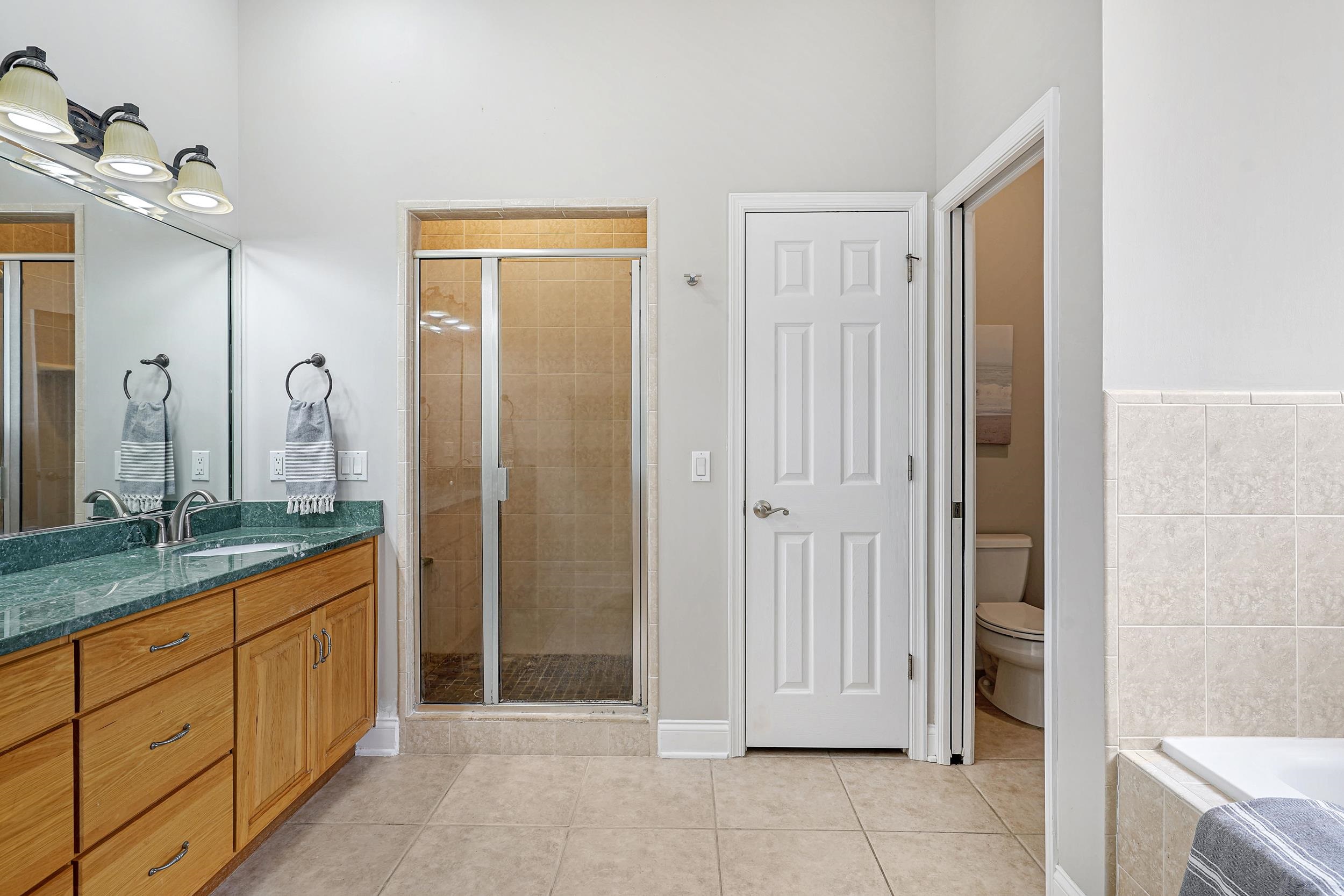 509 Twentieth Street St. Augustine, FL 32084 - Photo 21 of 40 a spacious bathroom with a mirror sink and shower