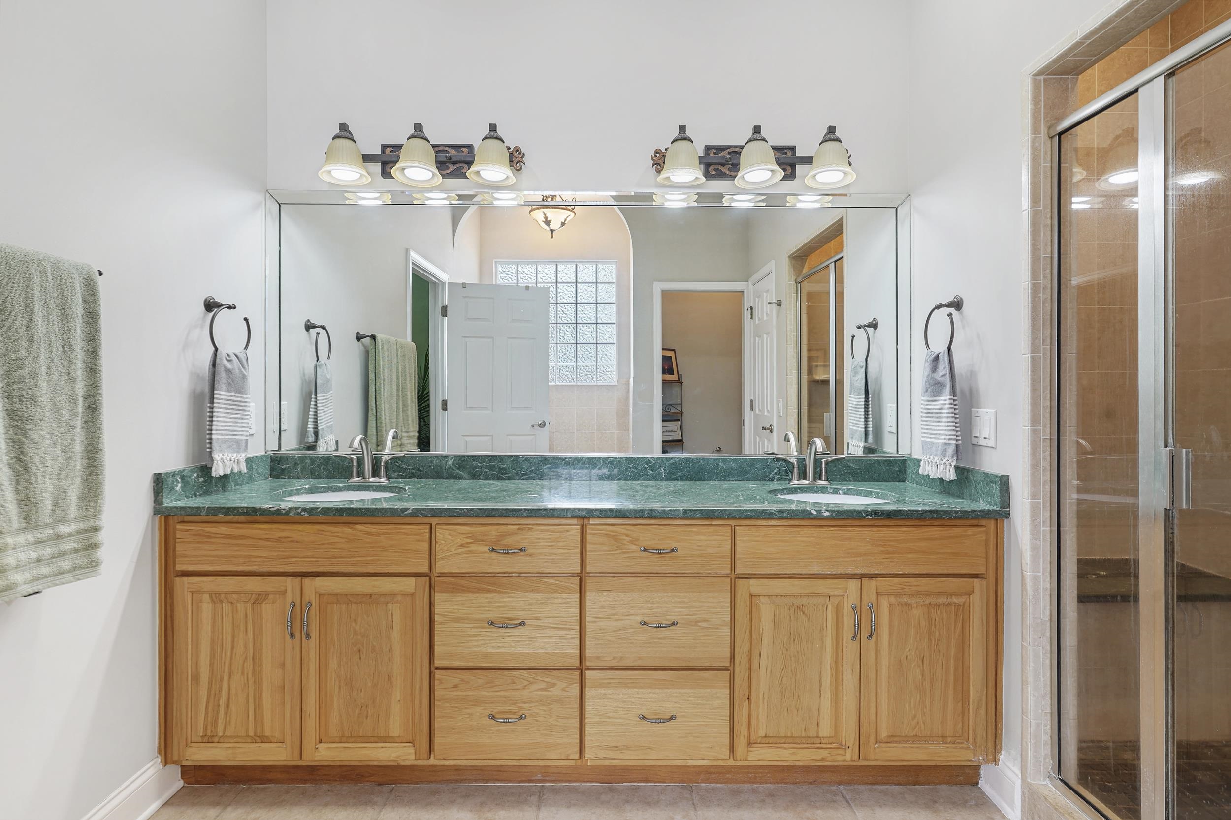 509 Twentieth Street St. Augustine, FL 32084 - Photo 22 of 40 a bathroom with a granite countertop double vanity sink and a mirror