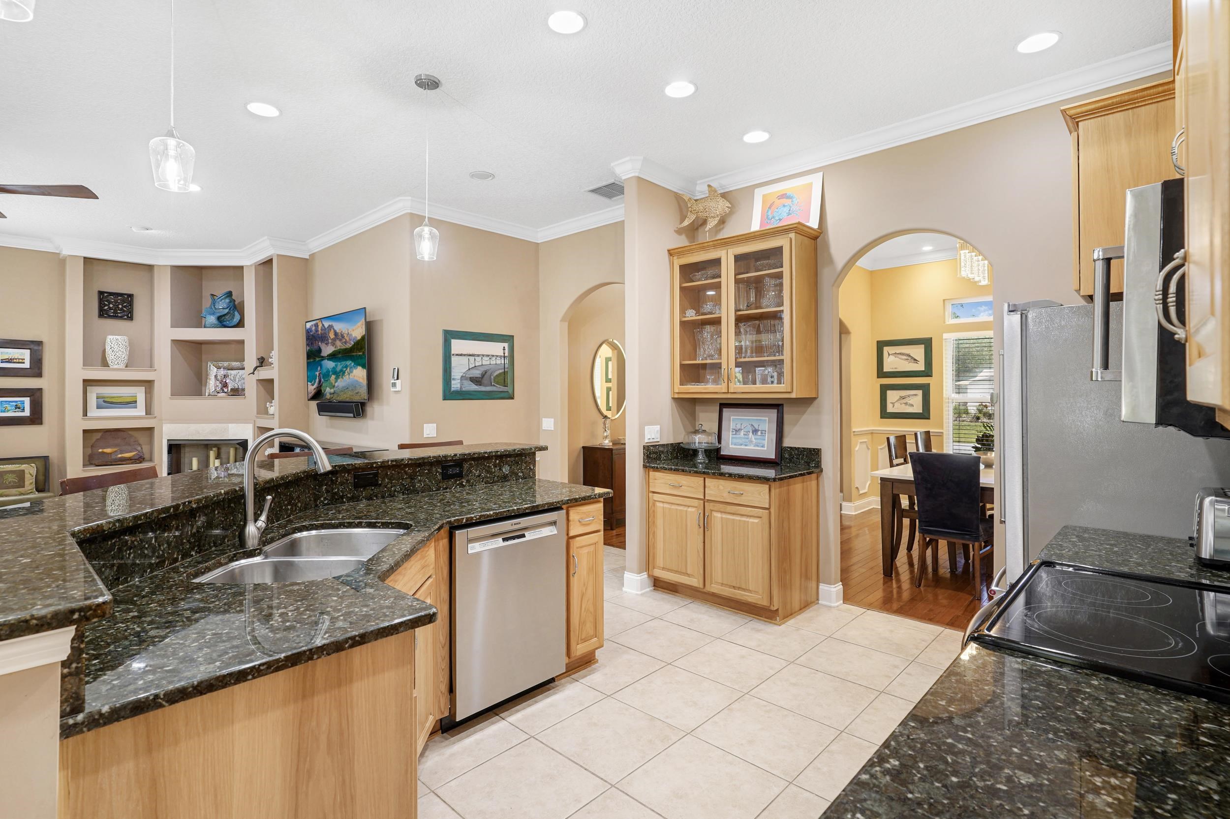 509 Twentieth Street St. Augustine, FL 32084 - Photo 3 of 40 a kitchen with stainless steel appliances granite countertop a sink and a stove