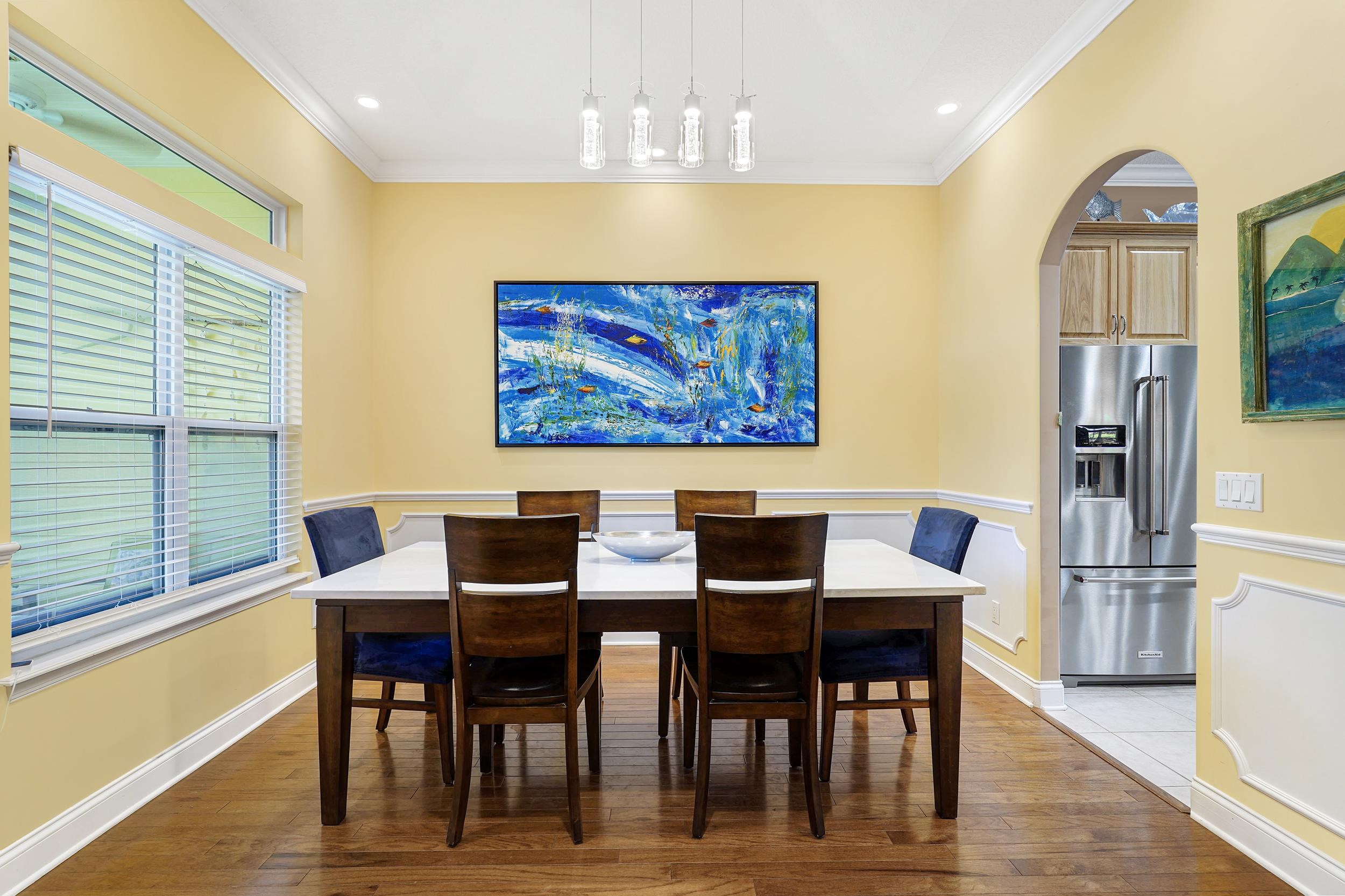 509 Twentieth Street St. Augustine, FL 32084 - Photo 8 of 40 a view of a dining room with furniture a chandelier and wooden floor