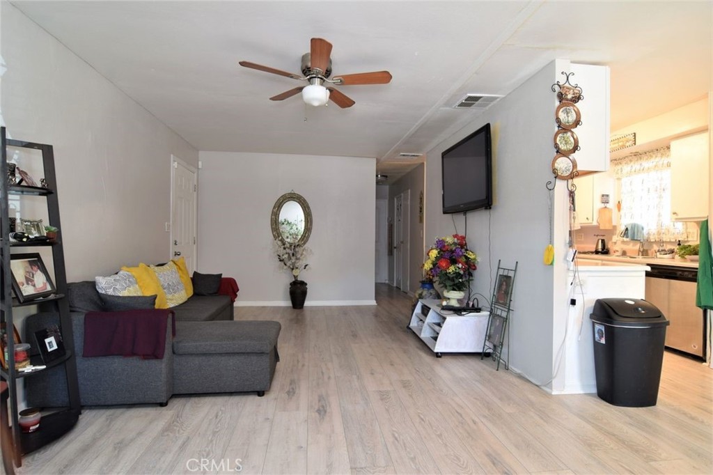 3255 East Avenue R, Unit 98 Littlerock, CA 92550 - Photo 12 of 12 a living room with furniture and a flat screen tv