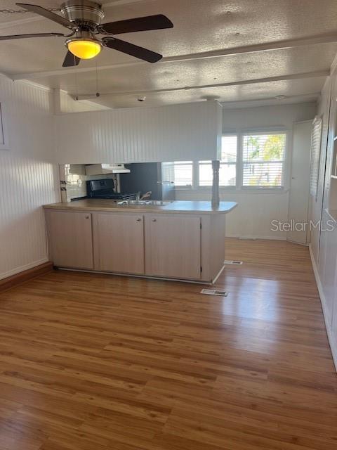 10315 Cortez Road West, Unit 15G Bradenton, FL 34210 - Photo 3 of 77 a kitchen with stainless steel appliances wooden cabinets and a wooden floor
