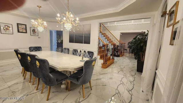 a view of a dining room with furniture and chandelier
