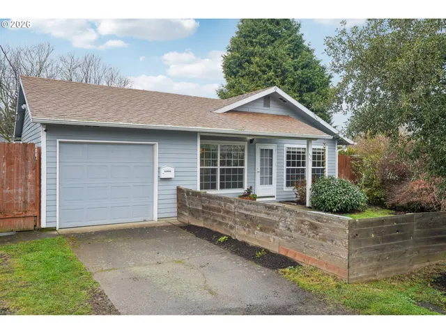 a front view of a house with a garden