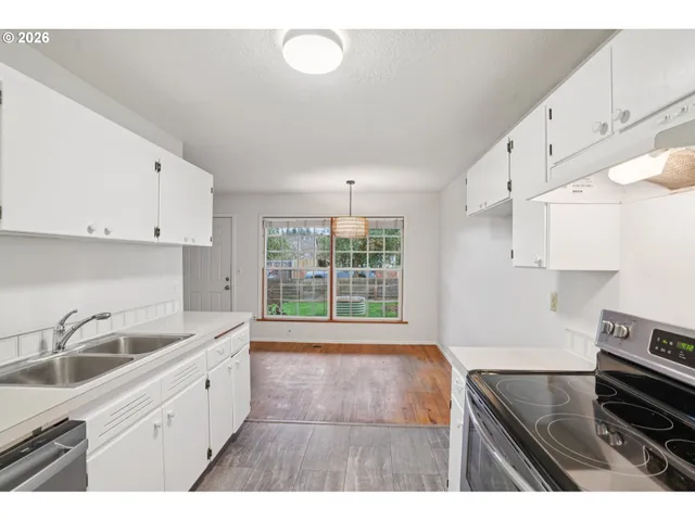 a kitchen with a sink stove and cabinets