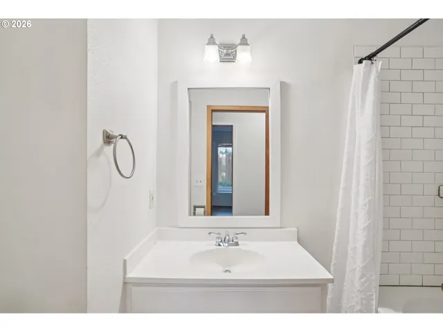 a bathroom with a sink vanity and a mirror