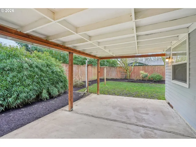 a view of a porch with furniture and garden