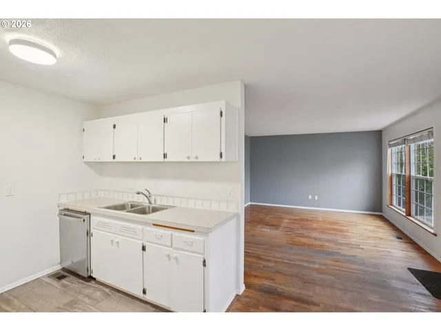 a kitchen with a sink cabinets and window