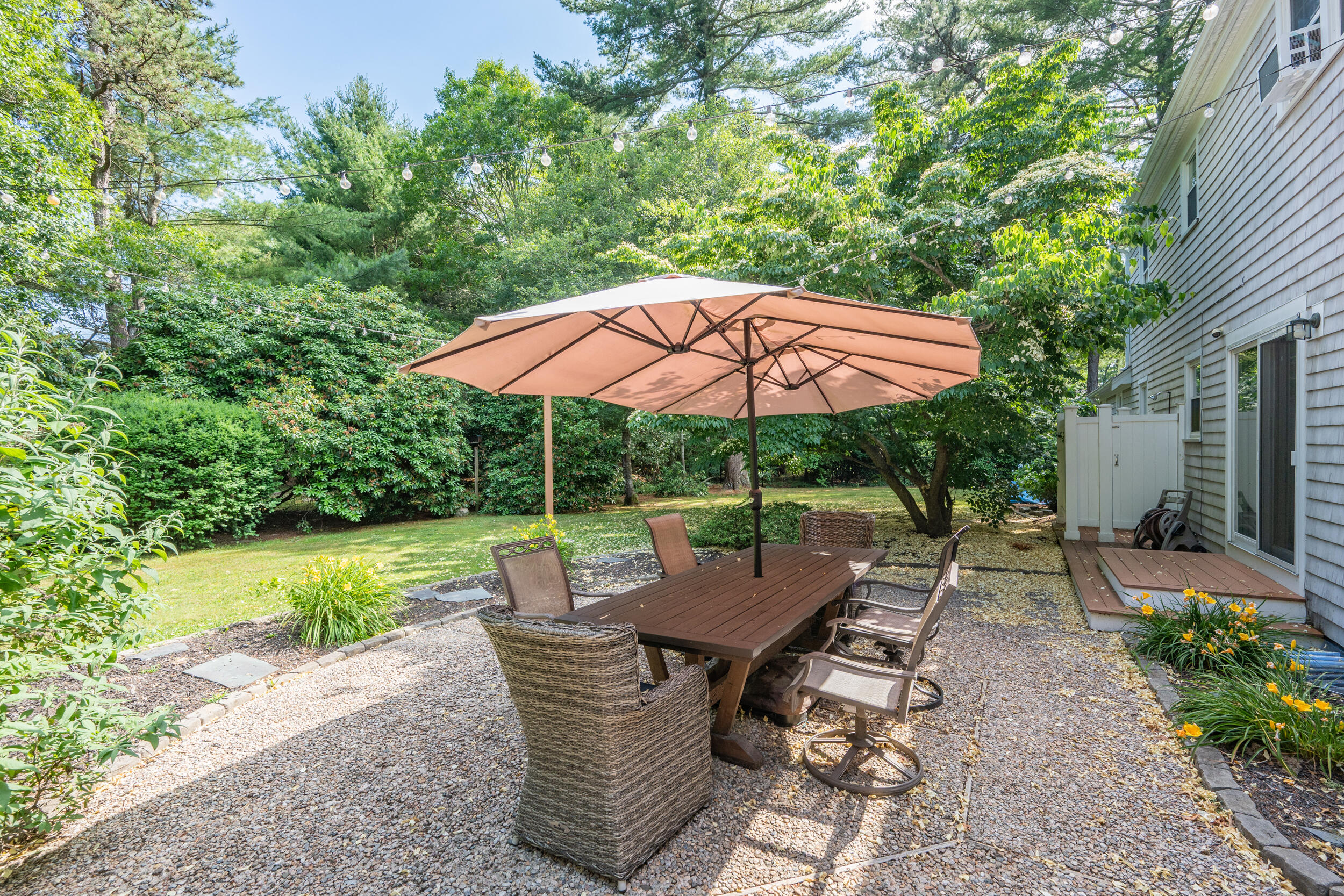 65 Hadrada Lane Centerville, MA 02632 - Photo 23 of 29 a view of patio with chairs and table under an umbrella