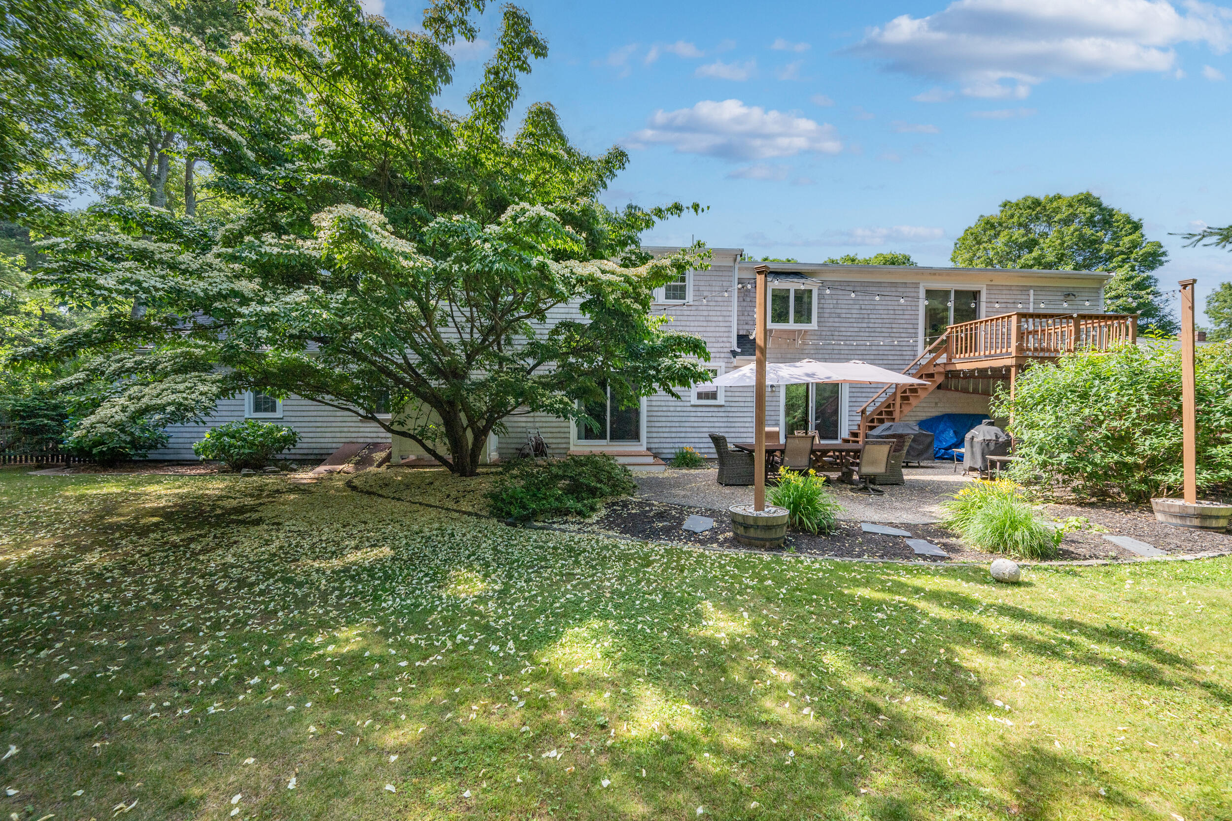 65 Hadrada Lane Centerville, MA 02632 - Photo 26 of 29 a view of backyard of house with outdoor seating and green space