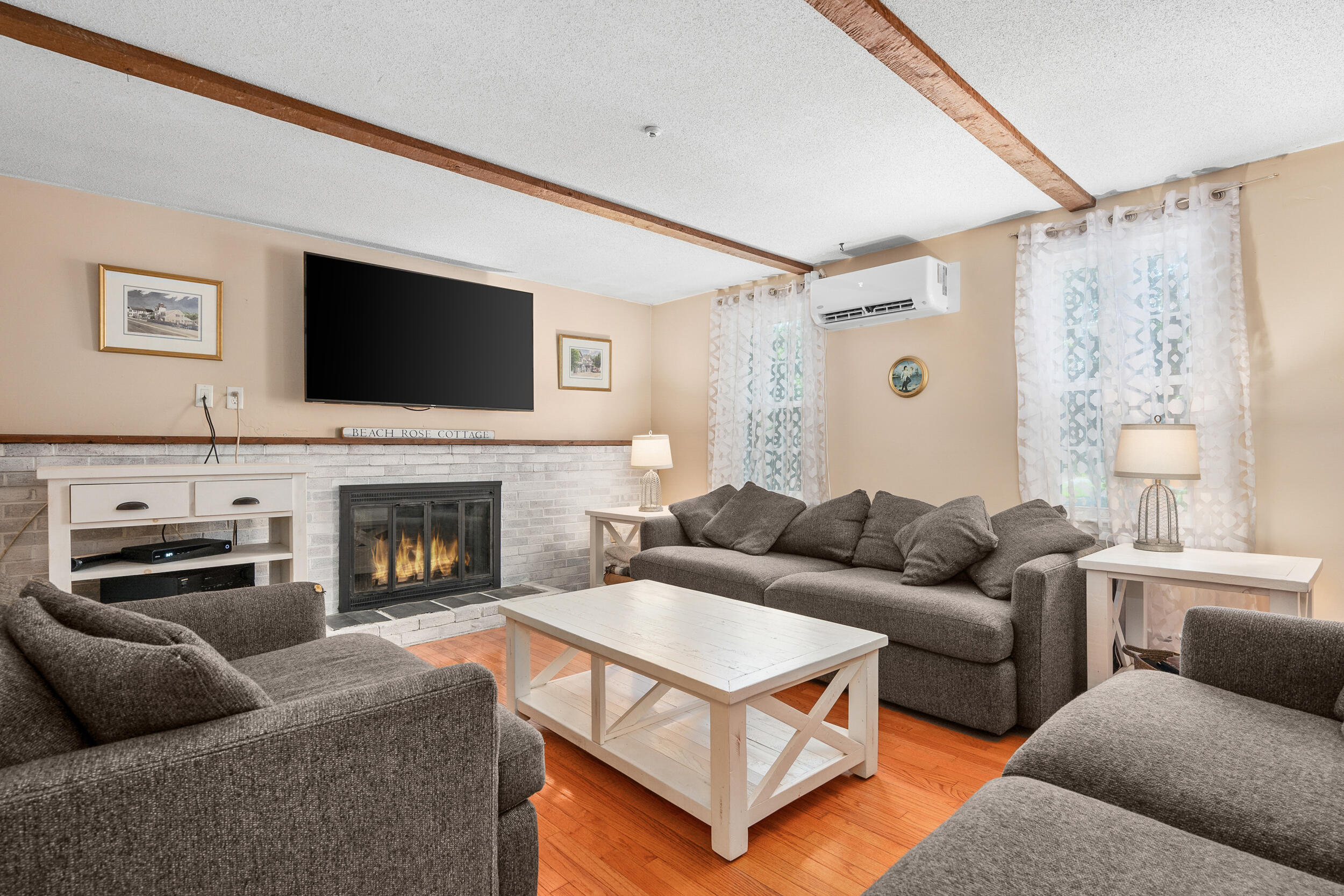 65 Hadrada Lane Centerville, MA 02632 - Photo 8 of 29 a living room with furniture a flat screen tv and a fireplace