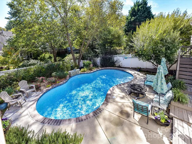 a view of a swimming pool with sitting area