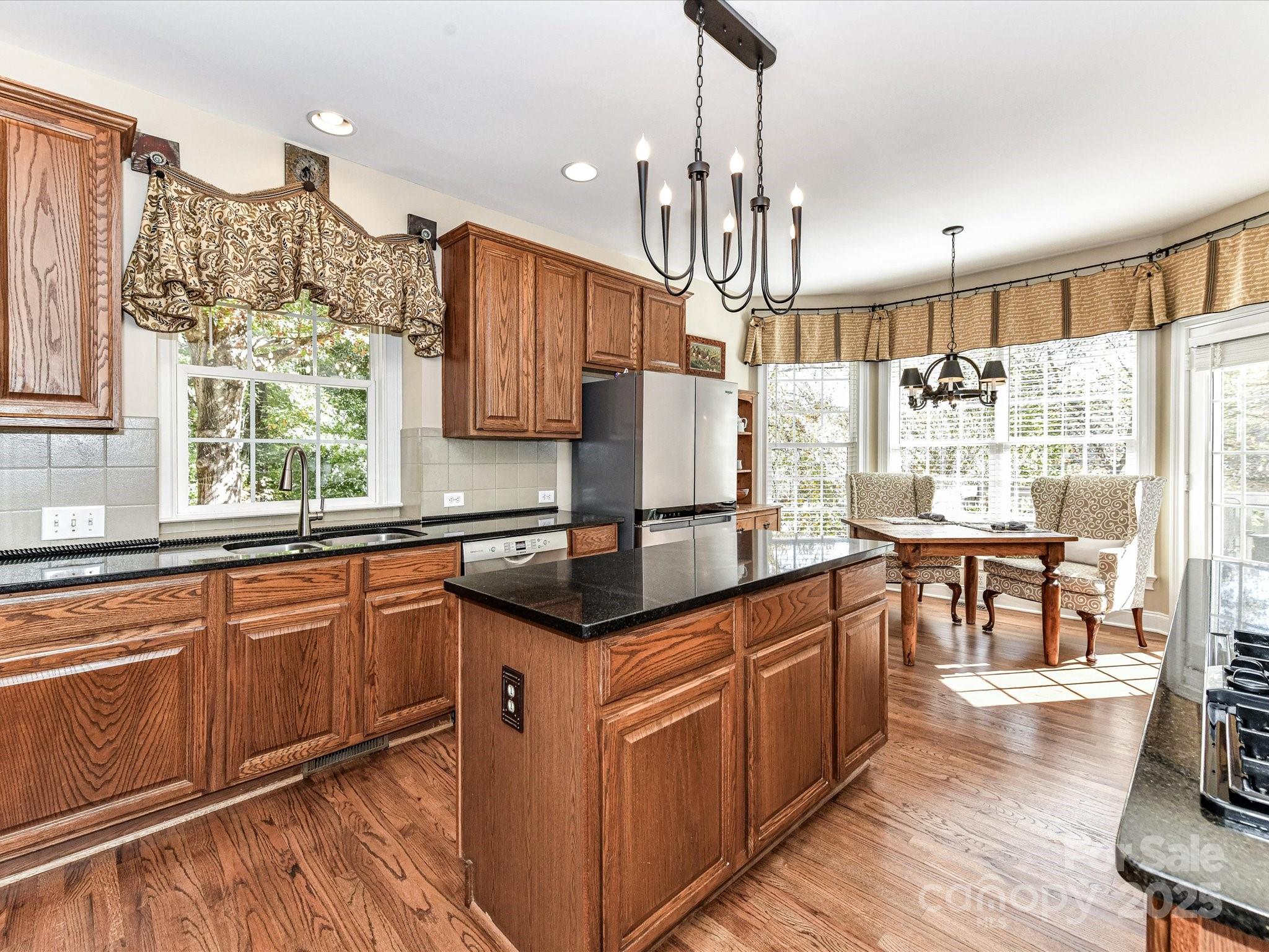 238 Fairview Lane Davidson, NC 28036 - Photo 12 of 40 a kitchen with stainless steel appliances granite countertop counter space a sink cabinets and wooden floor