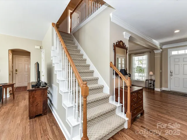 a view of entryway and hall with wooden floor