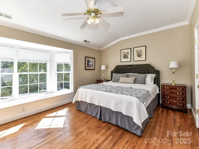 a bedroom with a large bed and a large window