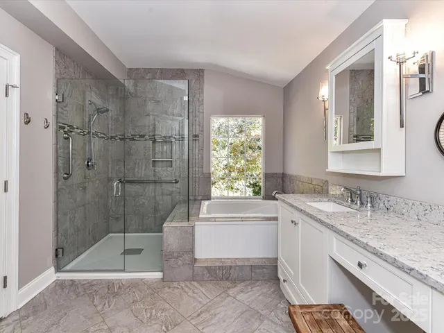 a bathroom with a granite countertop sink a toilet and bathtub