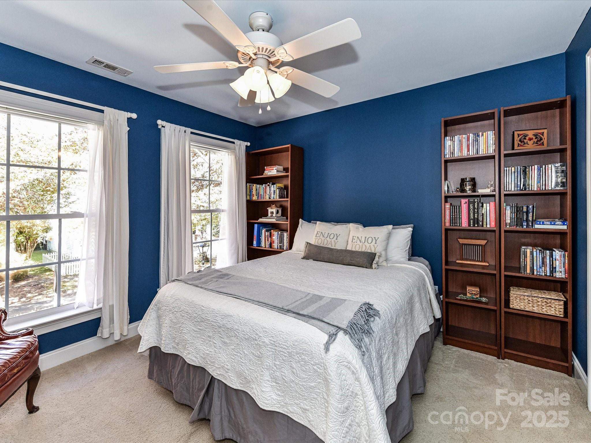 238 Fairview Lane Davidson, NC 28036 - Photo 23 of 40 a bedroom with a large bed and a chandelier