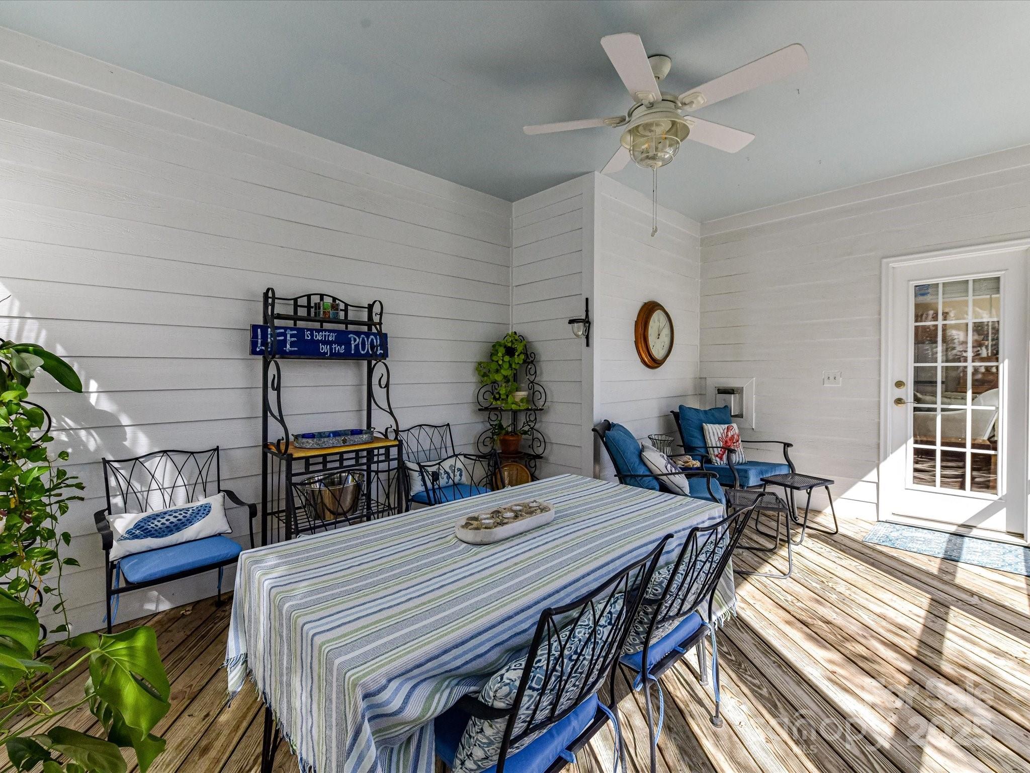 238 Fairview Lane Davidson, NC 28036 - Photo 29 of 40 a view of a dining room and livingroom with furniture wooden floor a rug a potted plant and a chandelier