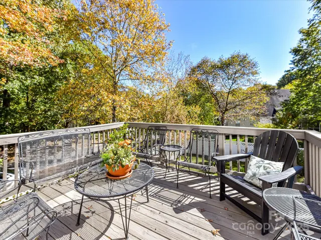 a view of balcony with wooden floor and outdoor seating