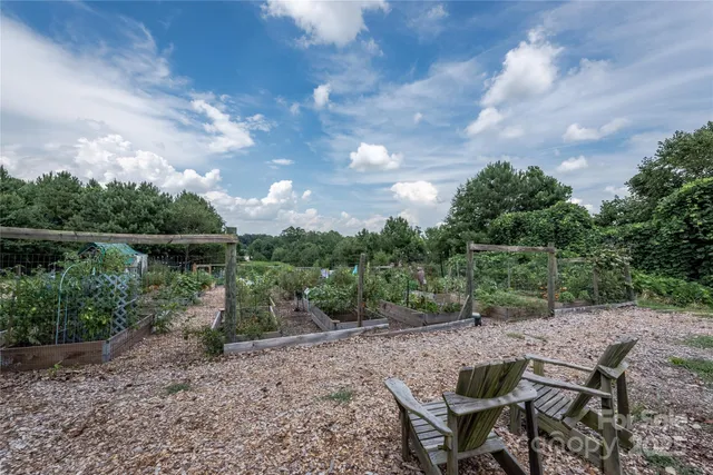a view of a lake with a yard and wooden fence