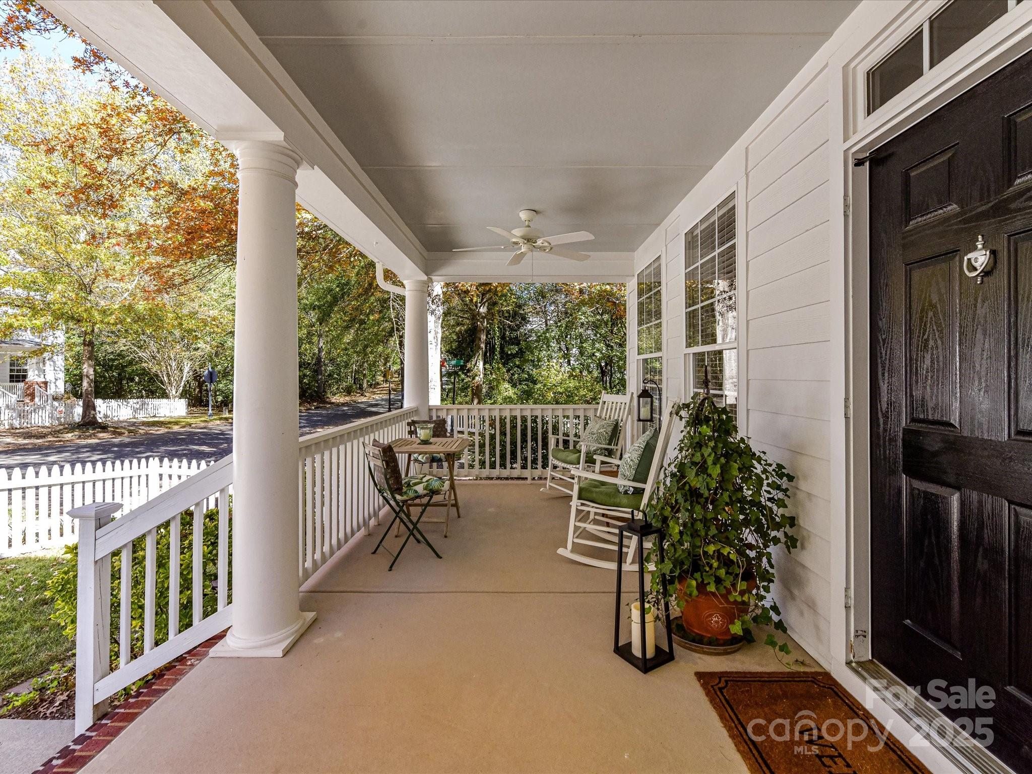 238 Fairview Lane Davidson, NC 28036 - Photo 6 of 40 a view of a porch with chairs and potted plants