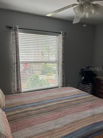 a bedroom with a bed and a painting on the wall