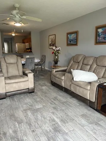 a living room with furniture and a mirror