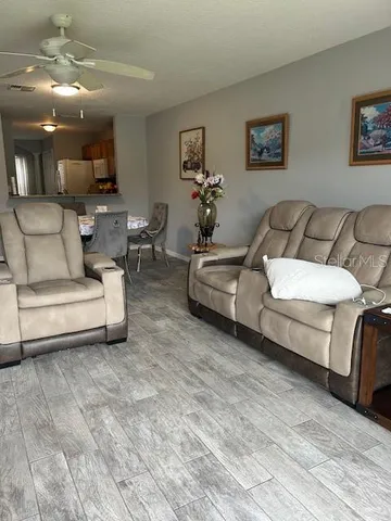a living room with furniture and a mirror