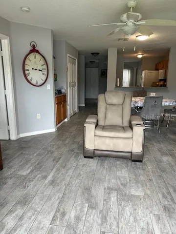 a living room with furniture and a clock