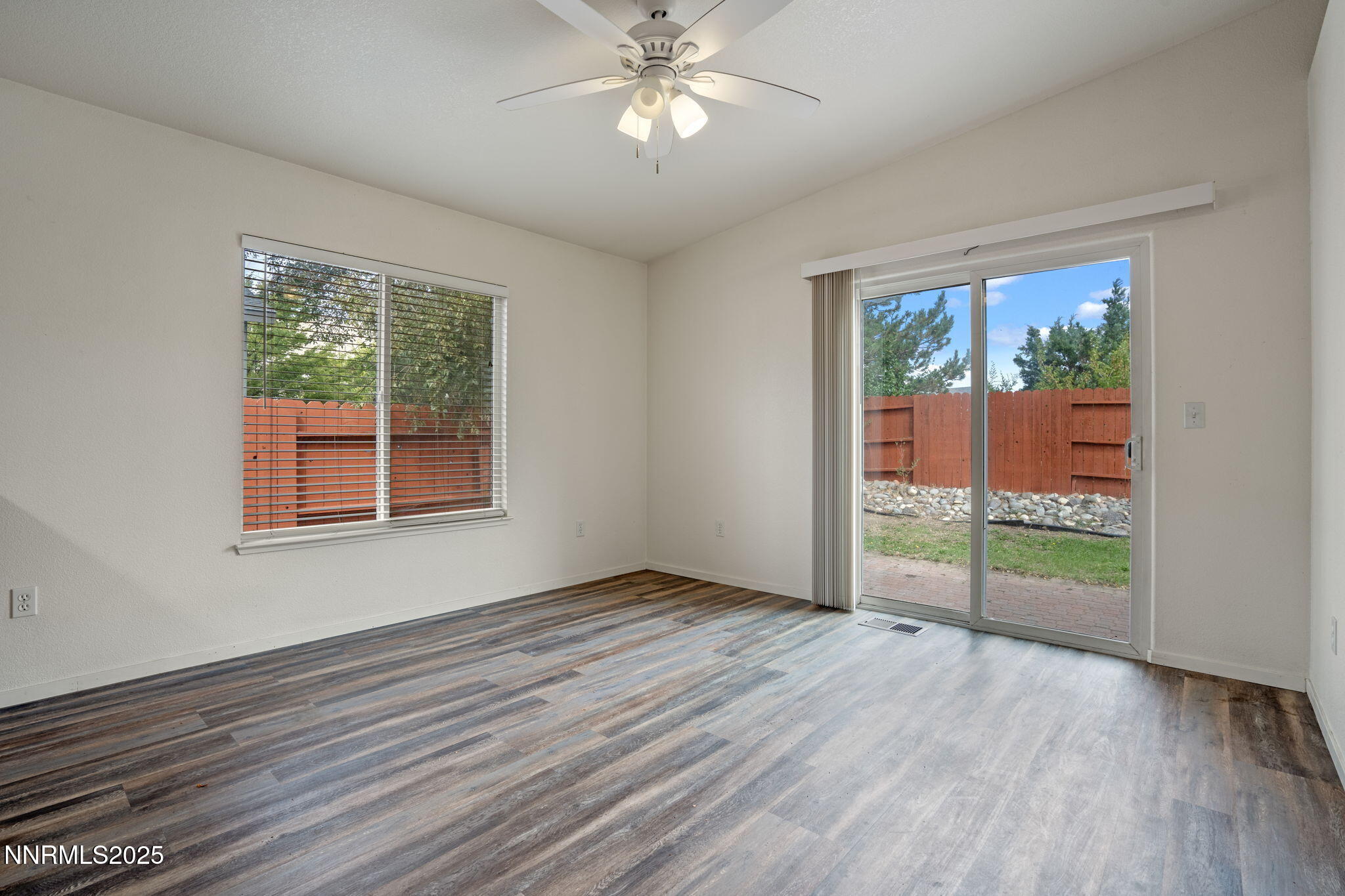 18197 Almondleaf Court Reno, NV 89508 - Photo 12 of 34 an empty room with wooden floor fan and windows