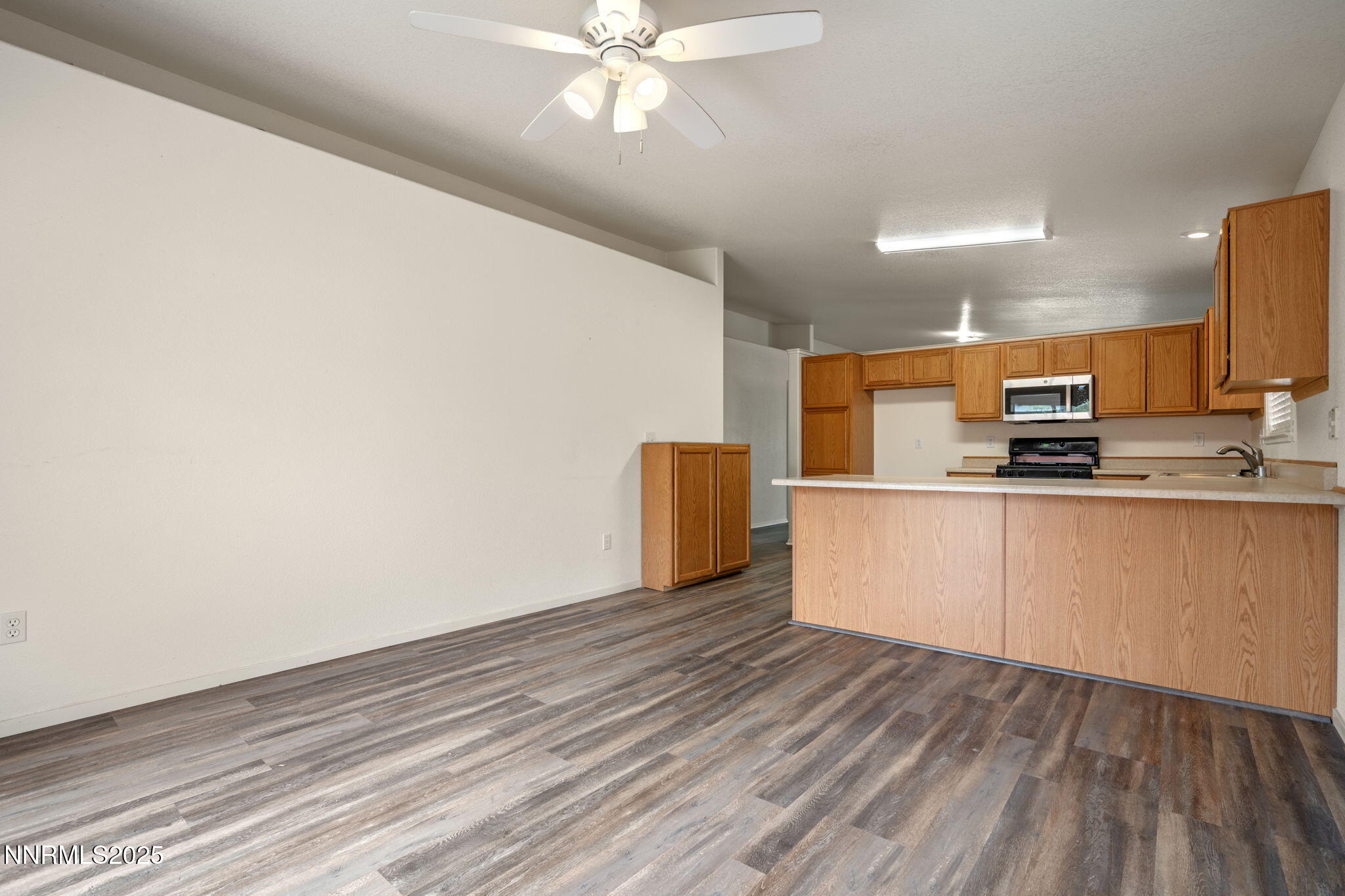 18197 Almondleaf Court Reno, NV 89508 - Photo 14 of 34 a kitchen with stainless steel appliances a refrigerator and a microwave