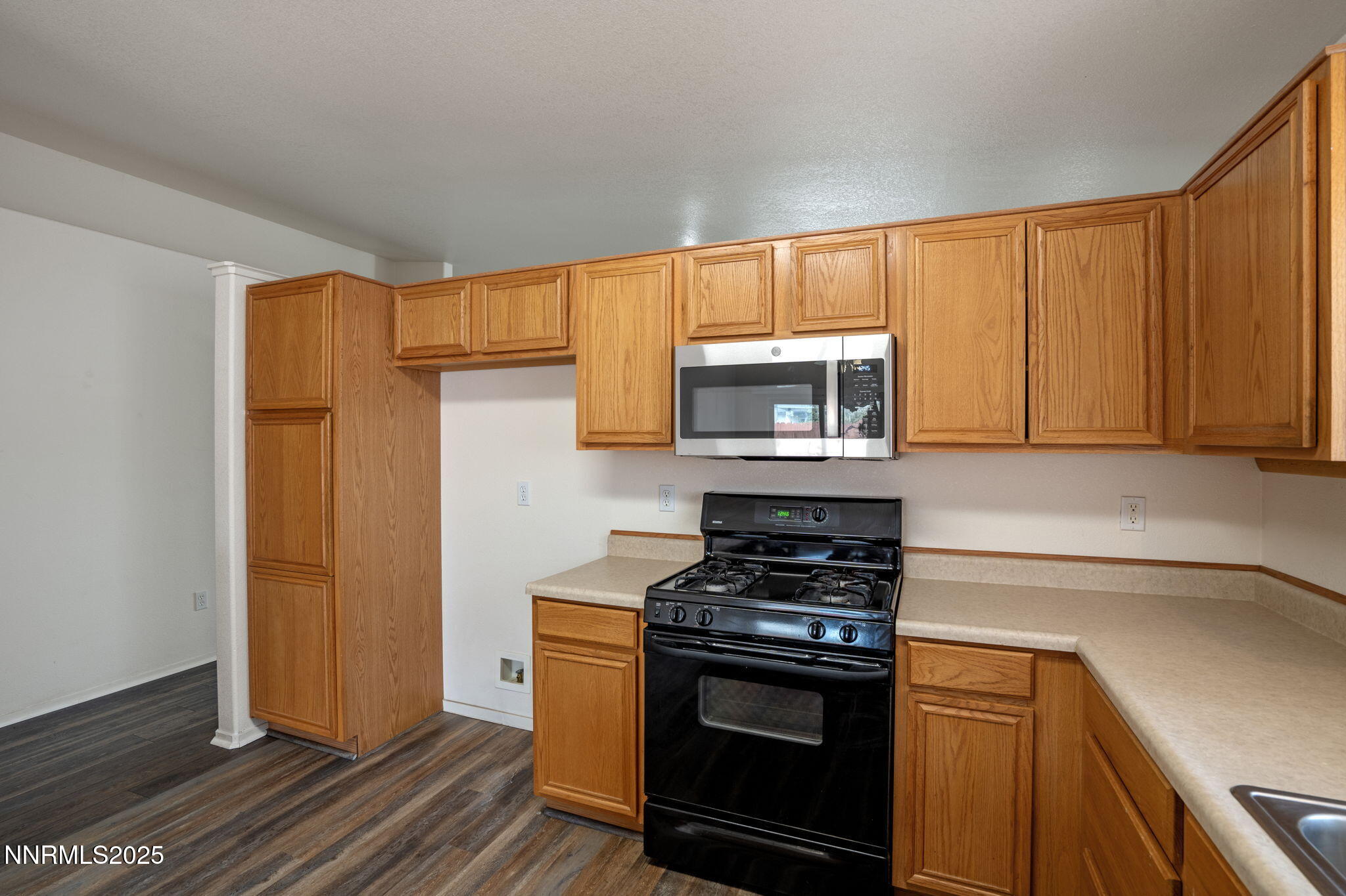 18197 Almondleaf Court Reno, NV 89508 - Photo 18 of 34 a kitchen with wooden cabinets and a stove top oven
