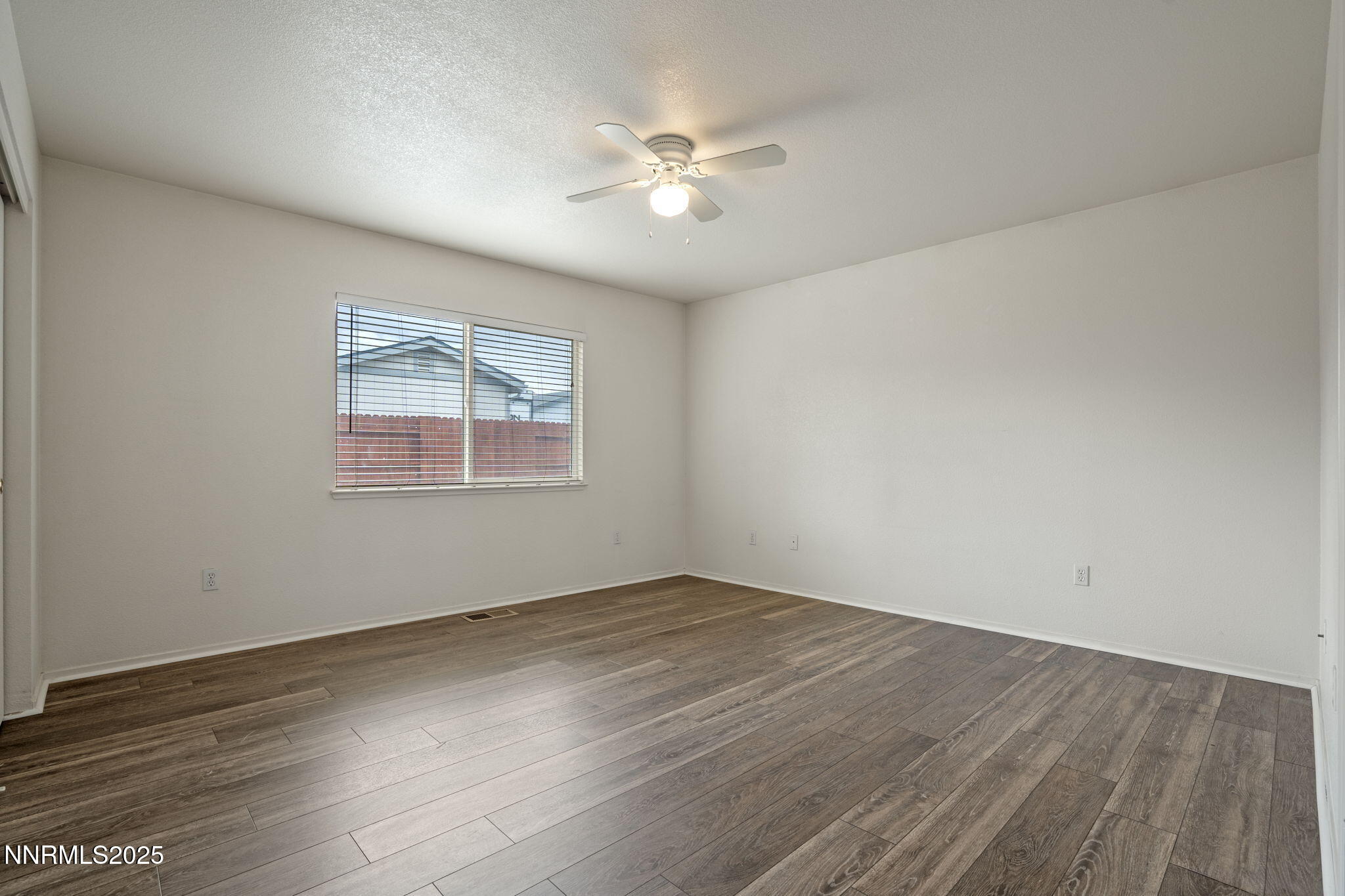 18197 Almondleaf Court Reno, NV 89508 - Photo 22 of 34 an empty room with wooden floor and windows