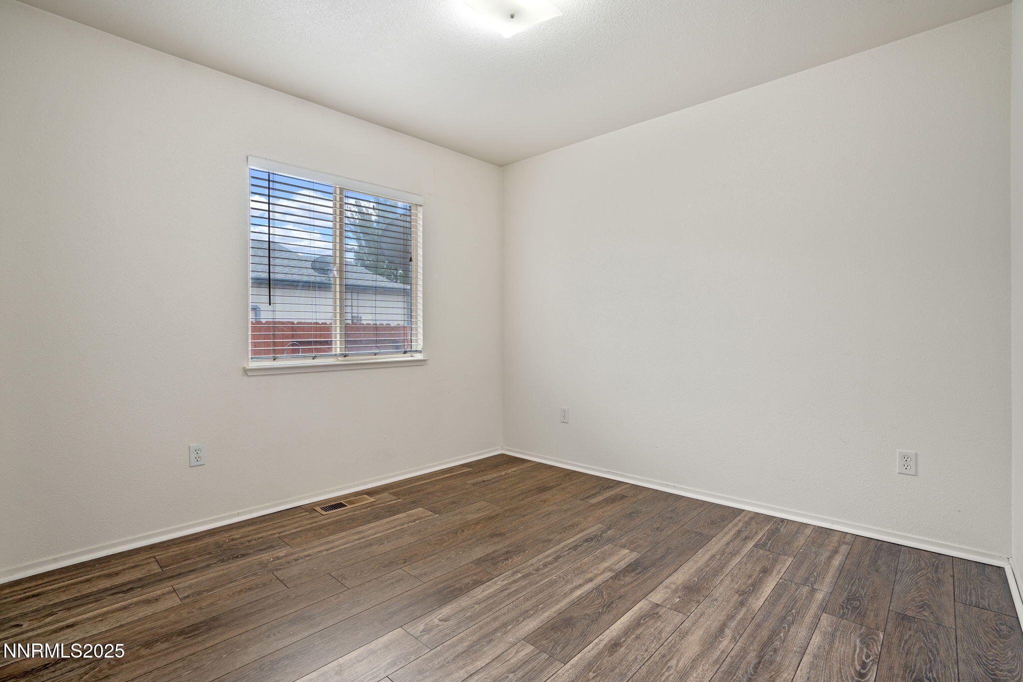 18197 Almondleaf Court Reno, NV 89508 - Photo 25 of 34 an empty room with wooden floor and windows