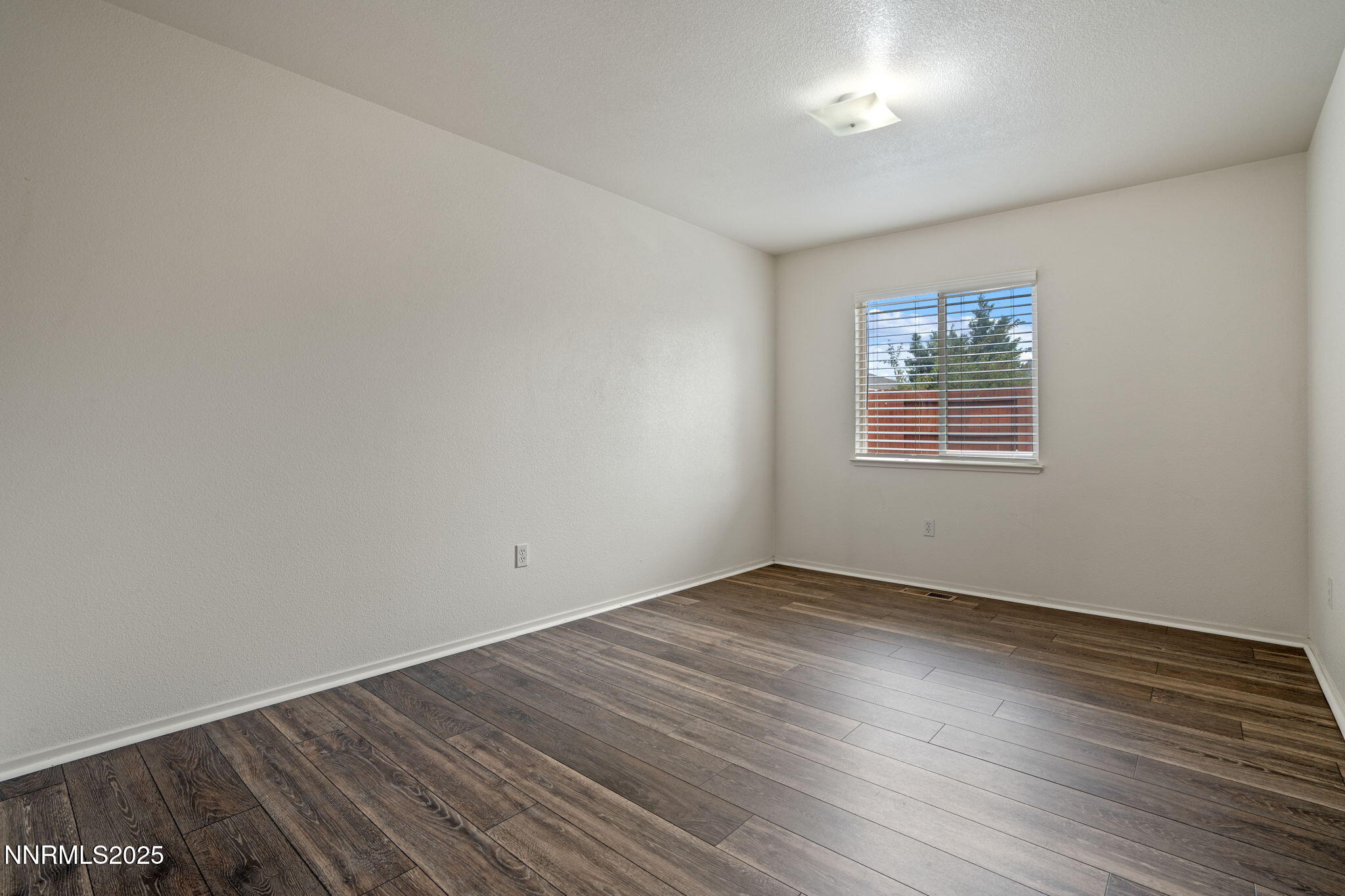 18197 Almondleaf Court Reno, NV 89508 - Photo 26 of 34 an empty room with wooden floor and windows