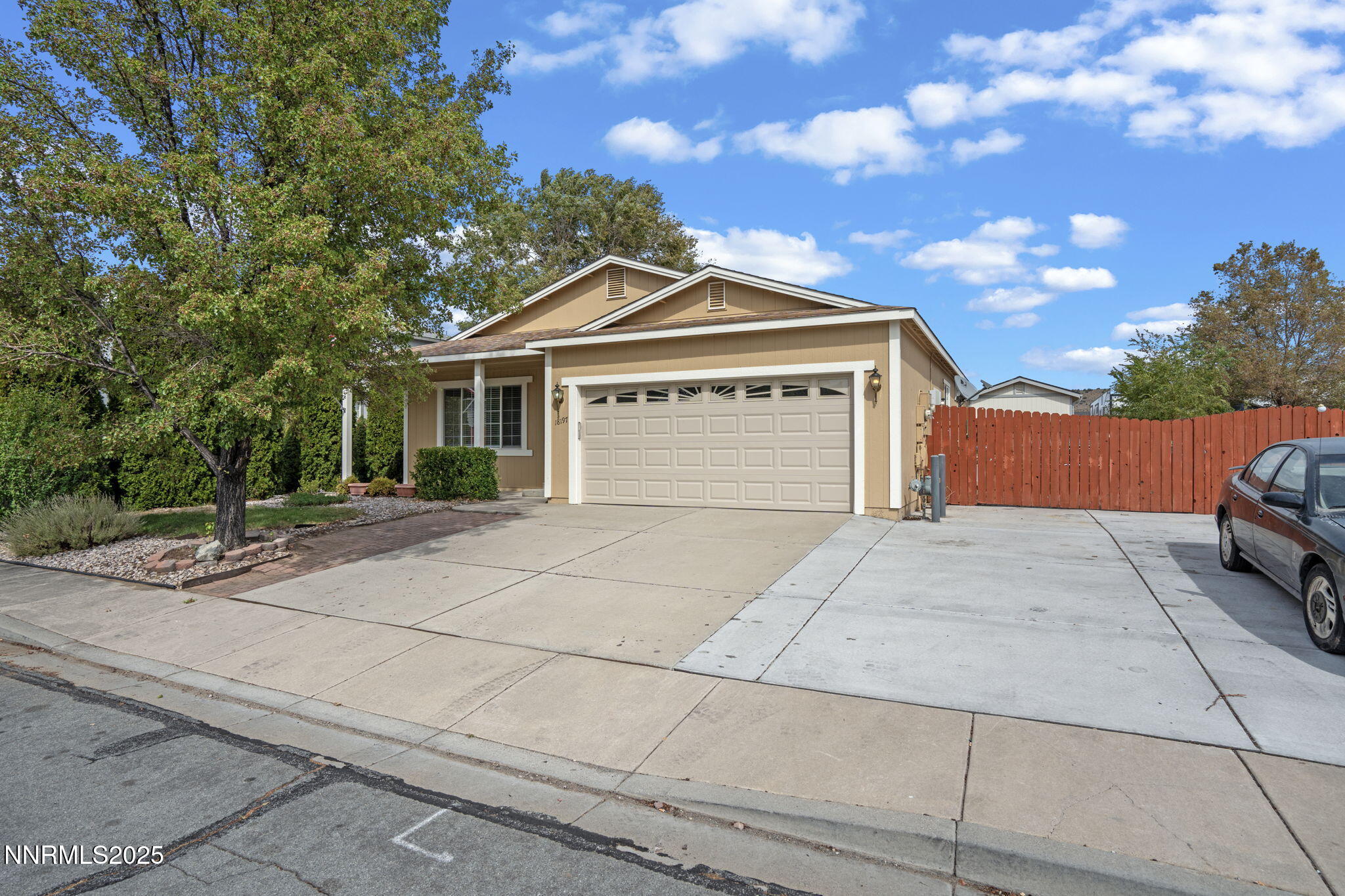 18197 Almondleaf Court Reno, NV 89508 - Photo 3 of 34 a front view of a house with a yard and garage