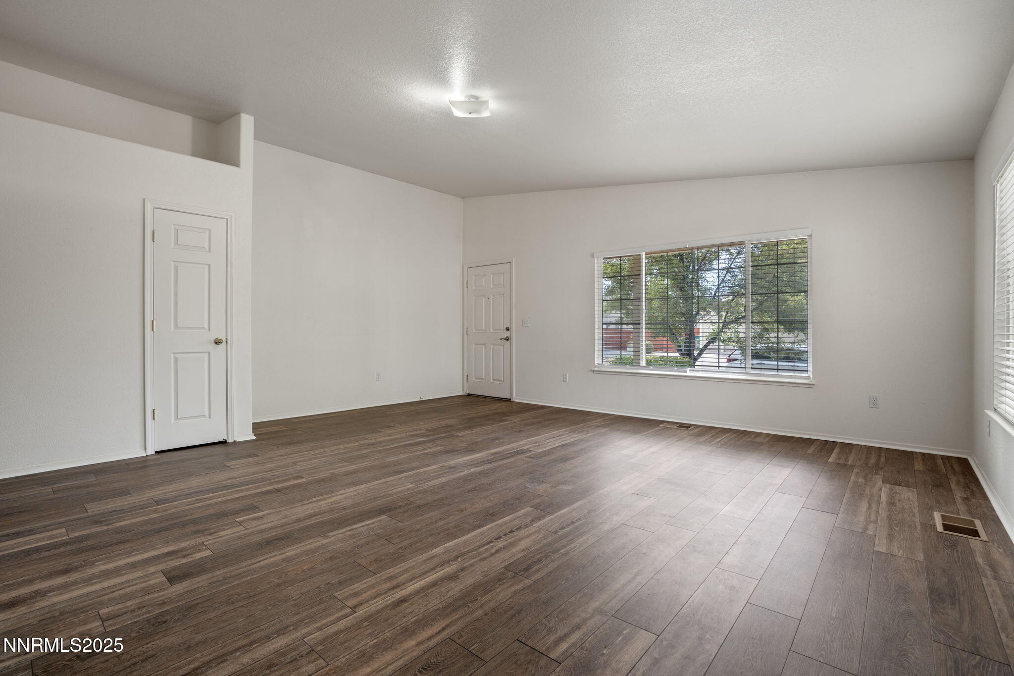 18197 Almondleaf Court Reno, NV 89508 - Photo 5 of 34 an empty room with wooden floor and windows