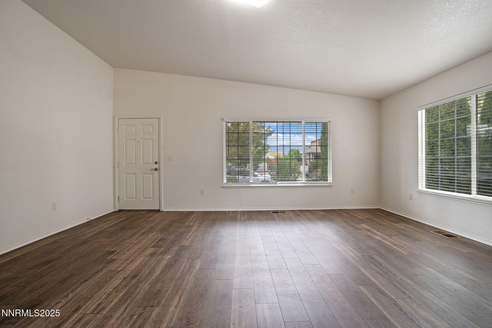 18197 Almondleaf Court Reno, NV 89508 - Photo 6 of 34 an empty room with wooden floor and windows