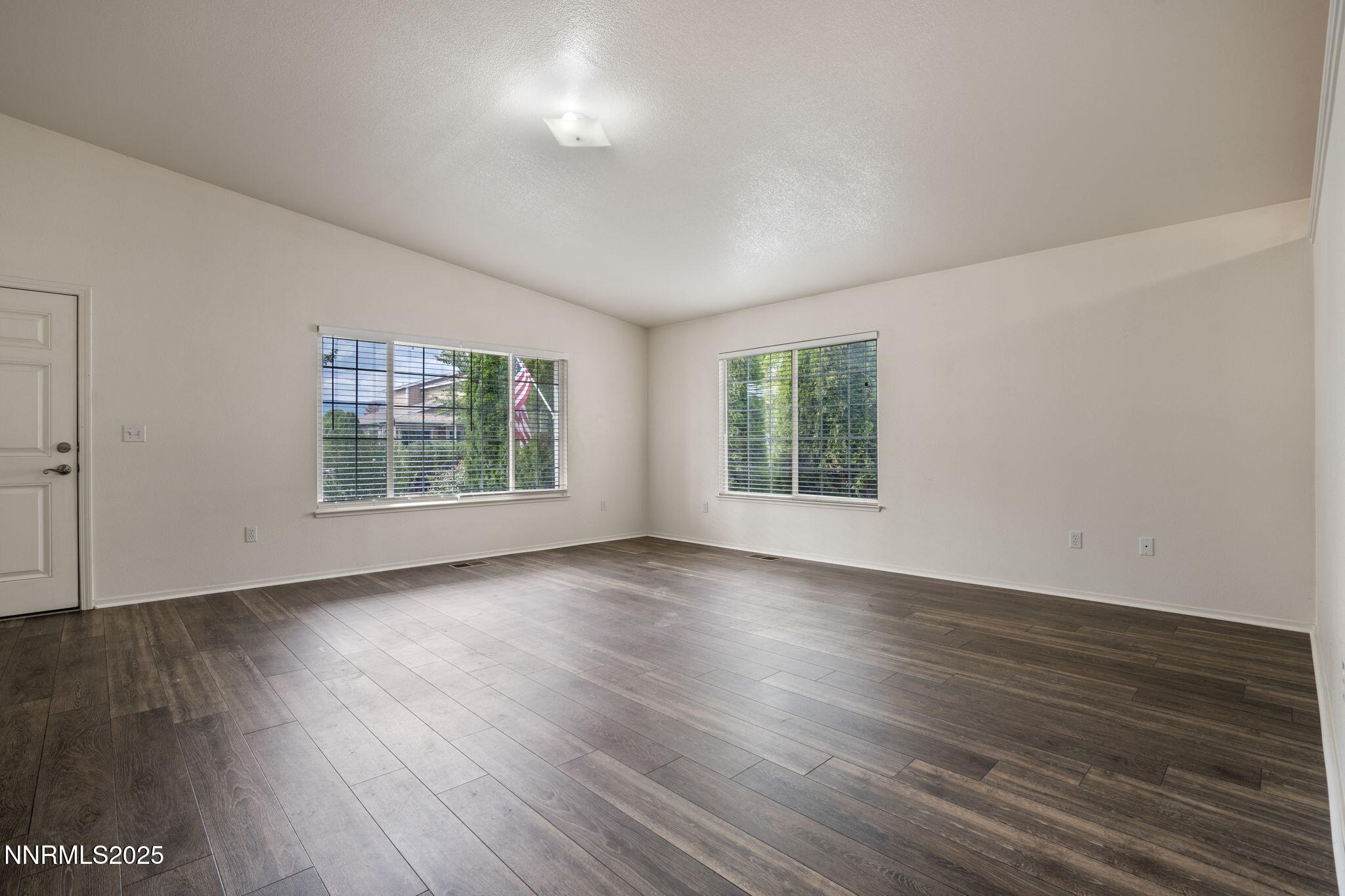 18197 Almondleaf Court Reno, NV 89508 - Photo 7 of 34 an empty room with wooden floor and windows