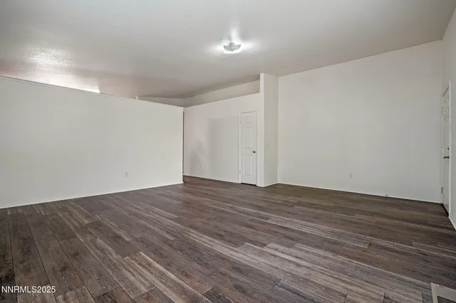 a view of room with wooden floor