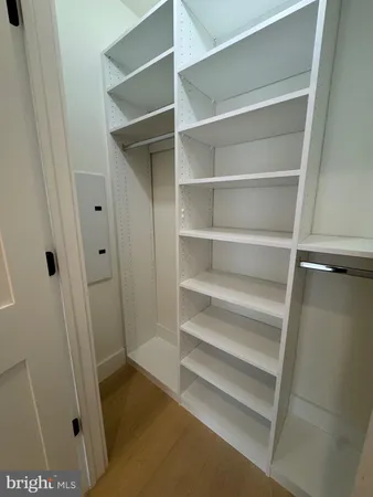 a view of walk in closet with empty racks