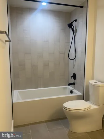 a bathroom with a toilet and a bath tub