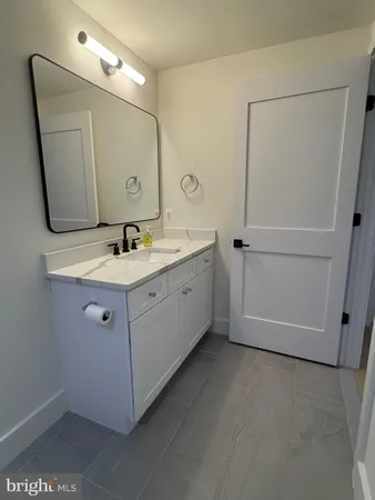 a bathroom with a double vanity sink and mirror