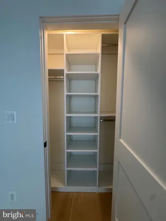 a view of walk in closet with empty racks