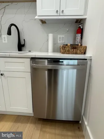 a stove top oven sitting inside of a kitchen